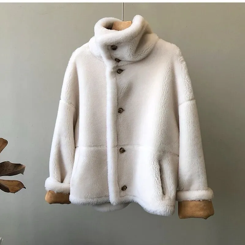 Winter luxury: faux leather shearling coat lined with real sheepskin. Double sided. for maximum warmth and style. Handmade